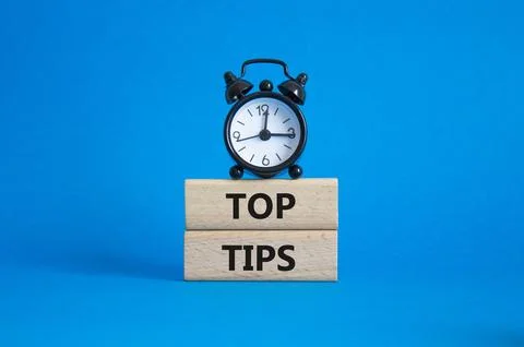 Top Tips symbol. Concept words Top Tips on wooden blocks. Beautiful blue ba.. Stock Photos