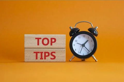 Top Tips symbol. Concept words Top Tips on wooden blocks. Beautiful orange .. Stock Photos