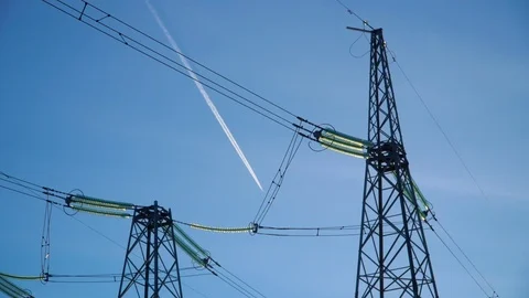 Top of two high voltage power transmission with wires against blue sky Stock Footage 106310126