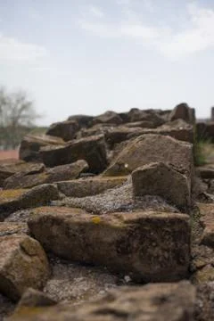 Top of various shaped stone wall of medieval fortress. 写真素材