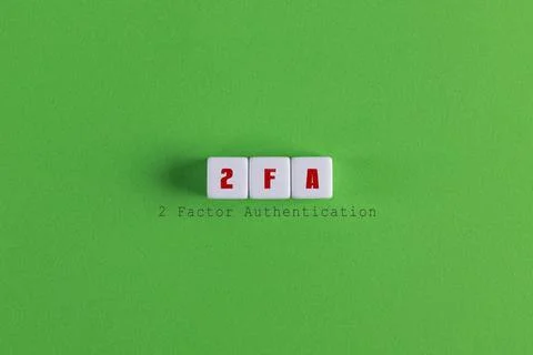 A top view of 2 factor authentication (2FA) banner with block letters on gree Stock Photos
