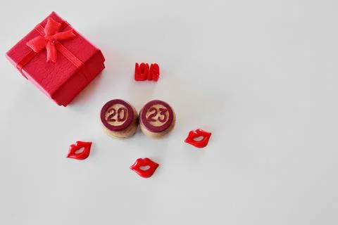 Top view of 2023 light background with red gift box, red lips and love word.  Stock Photos