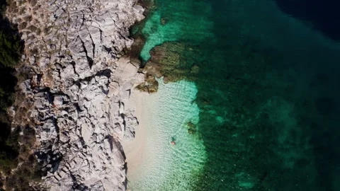 Top view 4K drone video of man dressed black swimming trunks entering and swimmi Stock-Footage 311832661