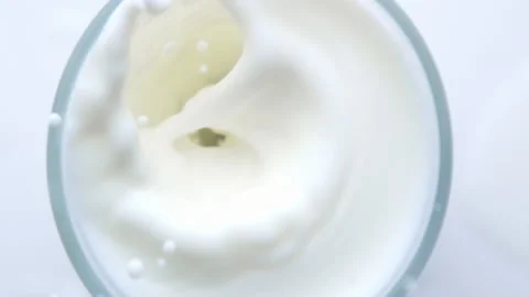 Top view from above blueberry falling into the glass with milk and make a splash Stock Footage 131153617