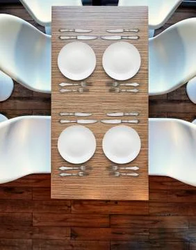 Top view from above on four empty plates on wooden table. Stock Photos