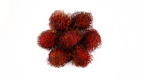 Top view from above of a heap of red color rambutan fruits. Slowly rotating Stock Footage 94018109