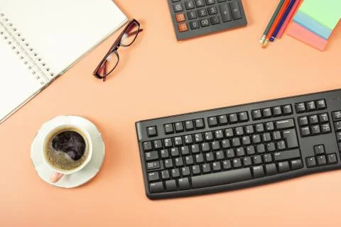 Top view from above of keyboard with notepad and coffee. Flat lay with blank  Stock Photos