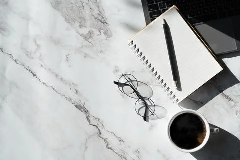 Top view above of marble pattern desk with keyboard computer, notebook and 写真素材
