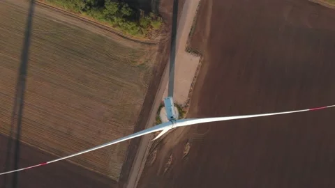 Top view above rotating wind turbine power plant aerial sunrise view shadow Stock Footage 143263979