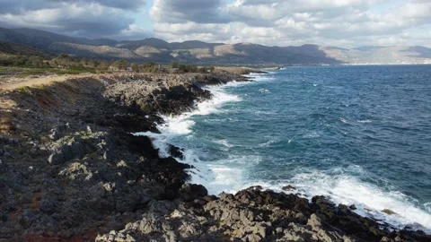 Top view from above of sea waves crashing and foaming on empty rock beach. Stock Footage 162353845