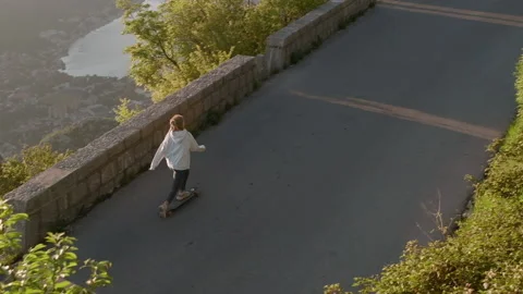 Top view of Active dreadlocks woman longboarding on mountain background Stock Footage 131742378