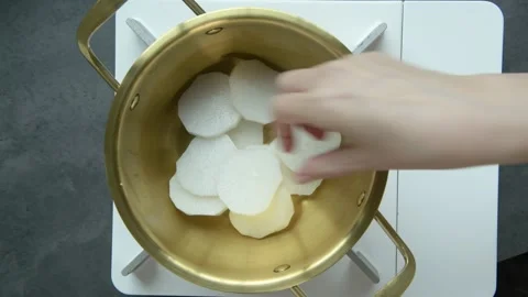 Top View of Adding Vegetables and Fish into Cooking Pot Stock Footage 335732828