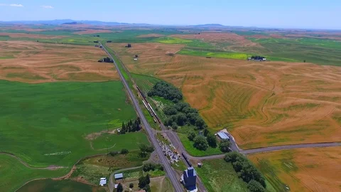 A top view aerial shoot of a train passing through the Palouse wheat fields. Stock Footage 75024597