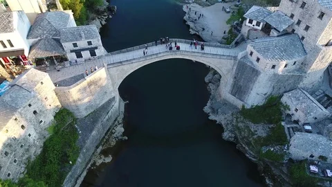 Top view aerial skyline of Mostar with the Mostar Bridge, houses and minarets Stock Footage 74551067