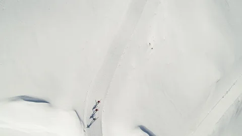 Top view aerial of three pro athletes cross-country skiing on groomed trails Stock Footage 121582241