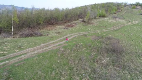 Top view aerial video of happy little child running on the meadow Video stock 74582282