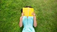 Top View Of African American Girl Lying On Green Grass And Reading Book. No Face Stock Photos