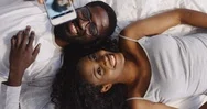 Top View On The African American Young Cheerful Man And Woman Lying On The Bed Stock Footage