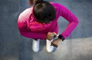 Top View On African Woman In Sportswear Looking At Smartwatch Stock Photos