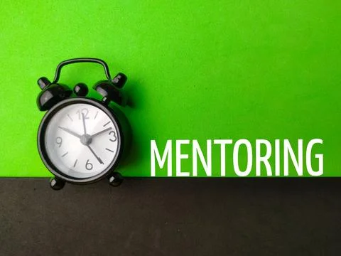 Top view alarm clock with text MENTORING Stock Photos