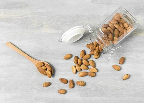 Top view almonds jar with spoons. High quality and resolution beautiful photo Stock Photos
