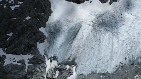 Top view of alpine glacier and fresh snowfield inside rocks Stockbeeldmateriaal 255210827