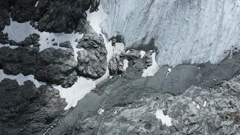 Top view of alpine glacier and fresh snowfield inside rocks Видео 255211044
