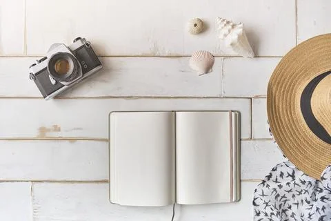 Top view of an analog camera and a notebook on a wooden table, photographer's Stock Photos