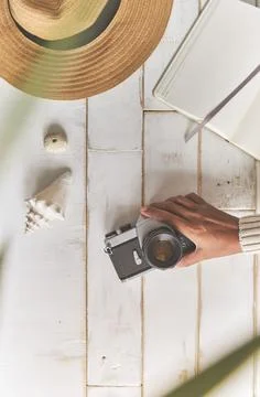 Top view of an analog camera and a notebook on a wooden table, photographer's Stock Photos