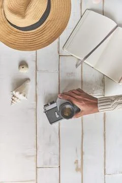 Top view of an analog camera and a notebook on a wooden table, photographer's Stock Photos