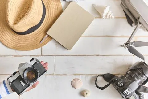 Top view of an analog camera and a notebook on a wooden table, photographer's Stock Photos