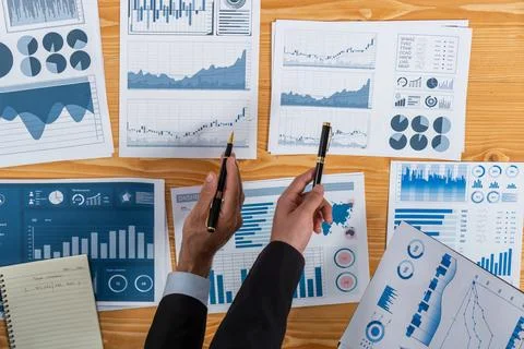 Top view analyst team working on dashboard paper on table. Fervent Stock Photos