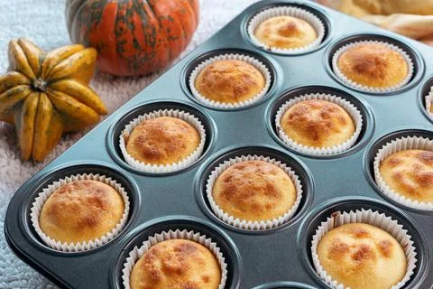Top view and close up group homemade pumpkin muffins on wooden plank. Autumn Stock Photos