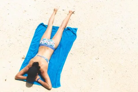 Top view and copy space of slim woman is lying sunbathe on the beach Stock Photos