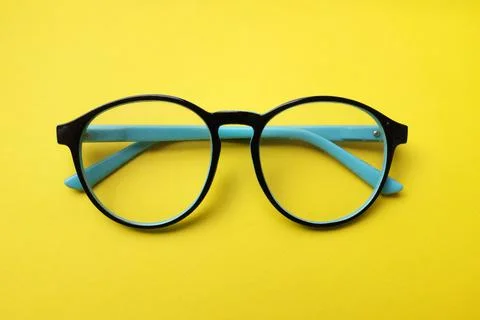 Top view and flat lay round black Eye Glasses isolate on a yellow Background Stock Photos