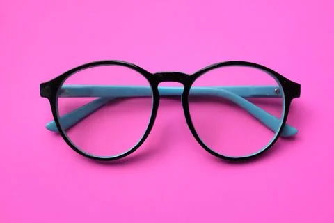 Top view and flat lay round black Eye Glasses isolate on a pink Background Stock Photos