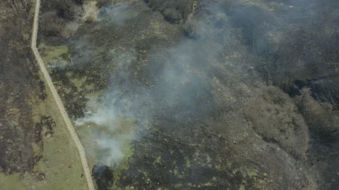 Top view and flying over the field with a line of fire. Epic video shooting Stock Footage 127689115