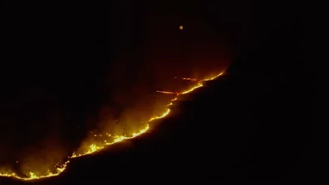 .Top view and flying over field with a fire, at night.  Dramatic video shooti Stock Footage 138166271