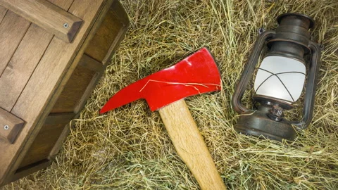 Top view and focus on the red ax, a kerosene lamp and an old wooden box. Stock Footage 127944612