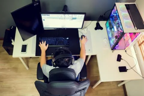 Top view and selective focus to black armchair and blurry Asian boy gamer. Stock Photos