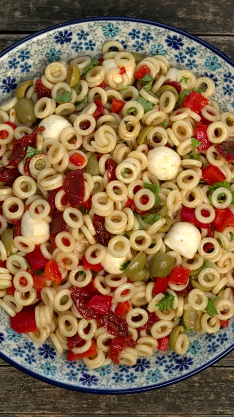Top view of anelli siciliani pasta salad. Vertical video. Video stock 299930705