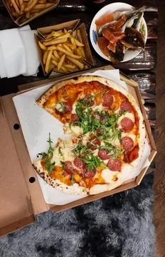 Top view appetizing pizza on the table, french fries with pizza on the tabl.. Stock Photos