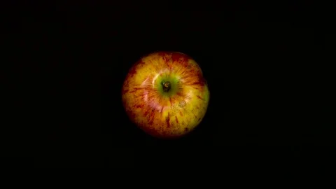 Top view of an apple and cutting it in half with a large knife  Stock Footage 72431923