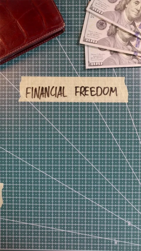 Top view of applying FINANCIAL FREEDOM handwritten tape near cash and calcu.. Stock Footage 338183672