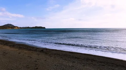 Top view with the approach of a wave of the sea surf with white foam on sand Stock Footage 105679243