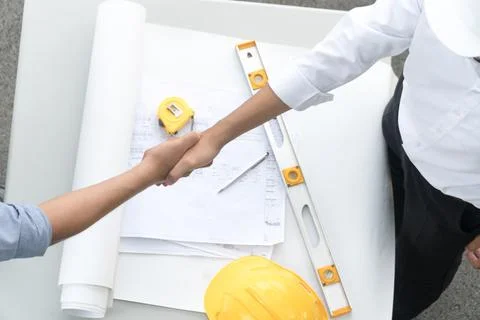 Top view architect and the engineering contractor shaking hands on building p Stock Photos