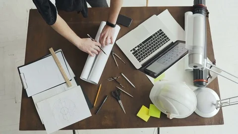 Top view. Architect working on blueprint. Architects workplace - architectural Stock Footage 83004419