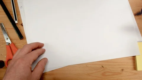 Top view, an architect's hand draws the square base for a house, ideal footage Stock Footage 104402167