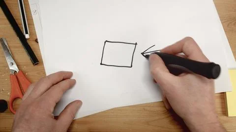 Top view, an architect's hand draws the square base for a house, ideal footage Stock Photos