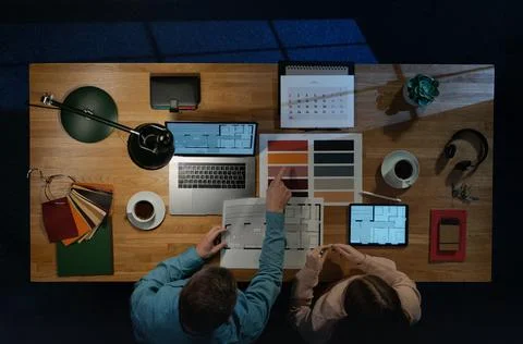 Top view of architects working on computer at desk with paperwork in home office Stock Photos